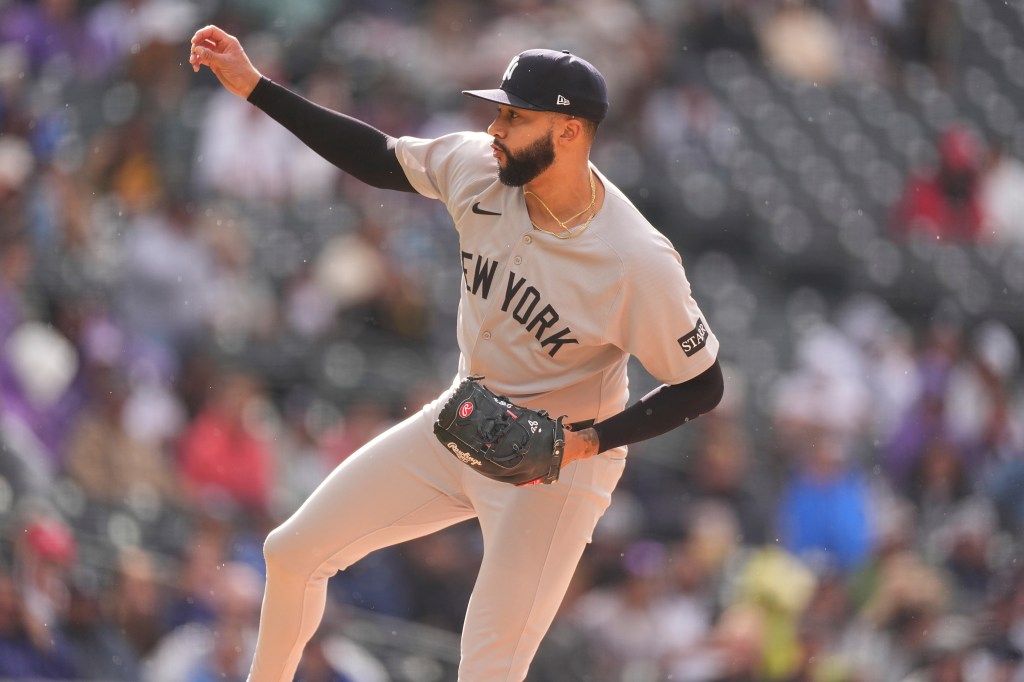 New York Yankees pitcher pitching a baseball game.