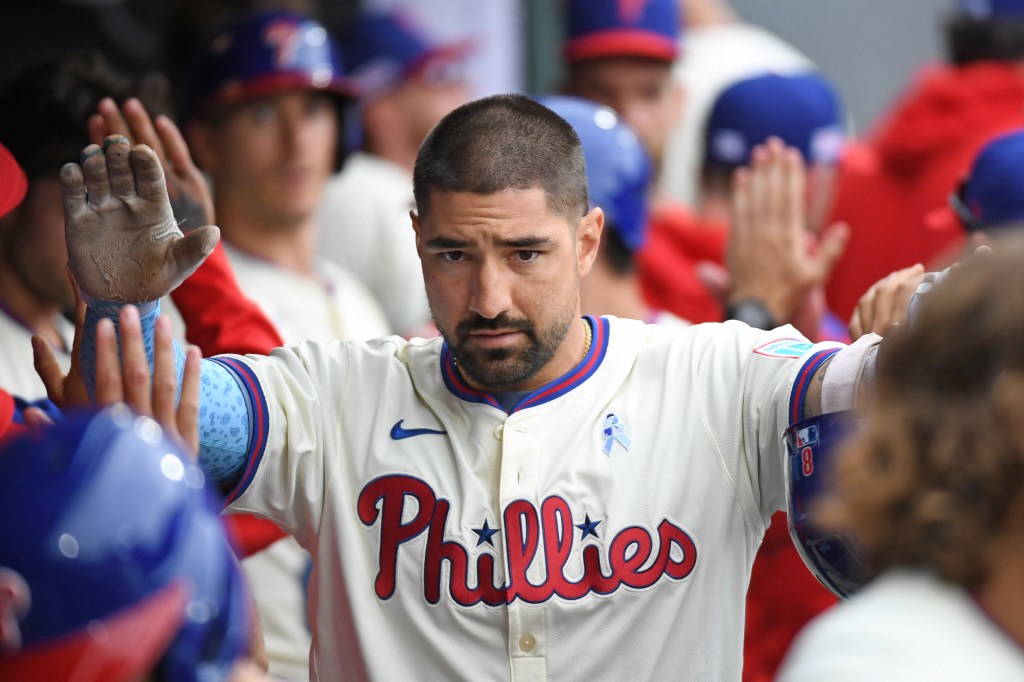 Nick Castellanos of the Philadelphia Phillies high-fiving teammates.
