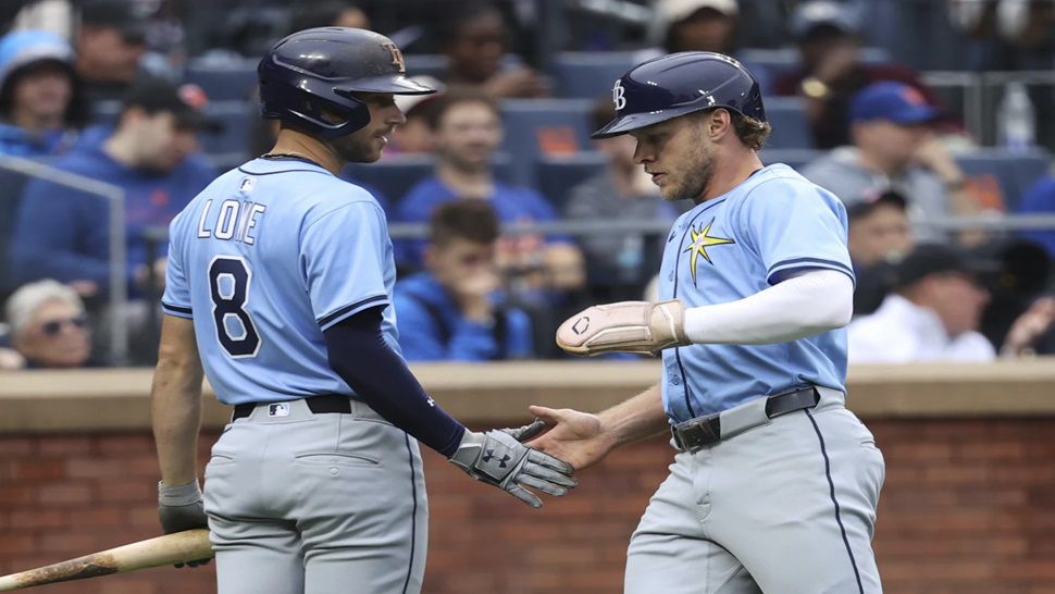 Tampa Bay Rays' Brandon Lowe, left, and Taylor Walls, right, react after Walls scored on a single hit by Josh Lowe during the third inning of a baseball game against the New York Mets Saturday, June 14, 2025, in New York. (AP Photo/Pamela Smith)