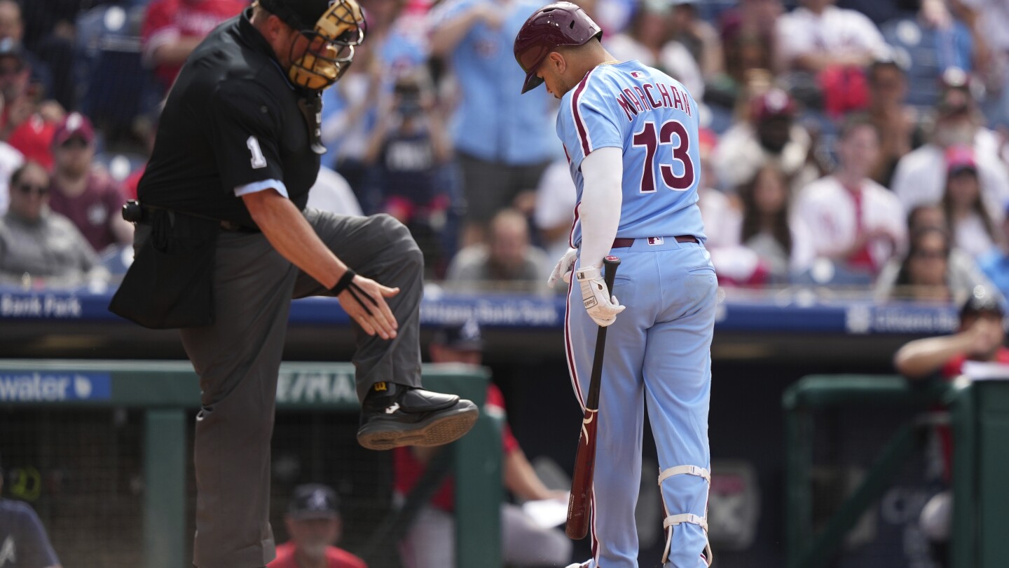 Marchán leads Harper-less Phillies over Braves 5-4 in doubleheader opener for 23rd win in 29 games
