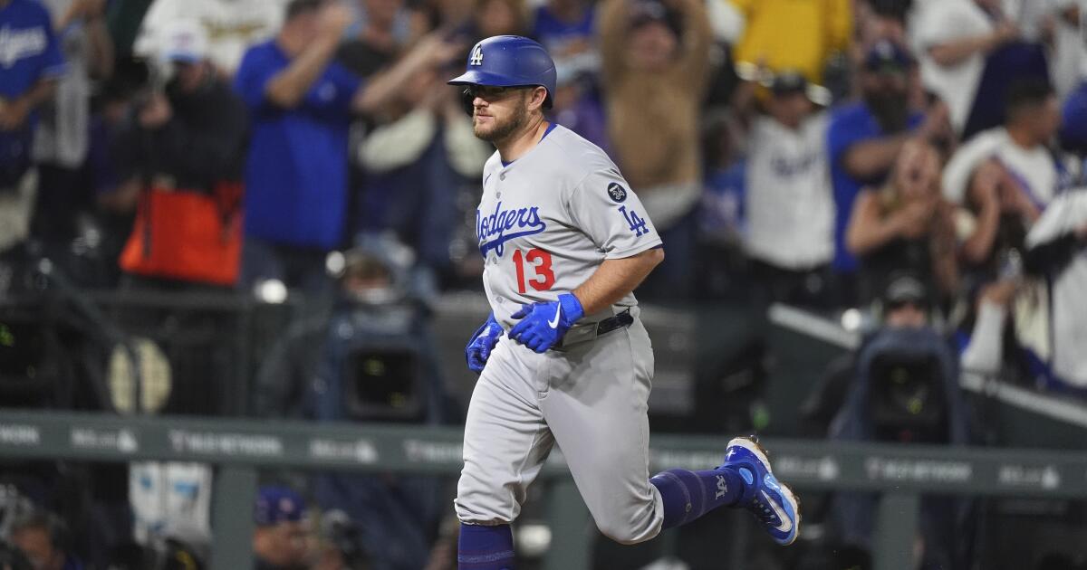 Max Muncy gets help from the rain, then hits a grand slam to lead Dodgers past hapless Rockies