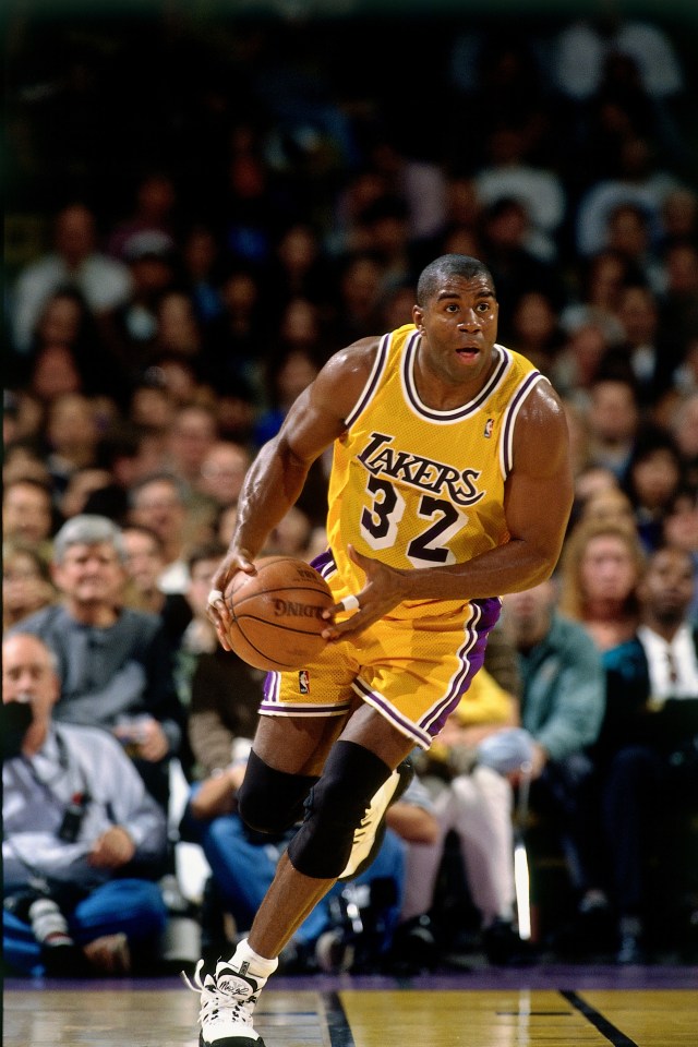Magic Johnson #32 of the Los Angeles Lakers dribbling a basketball.