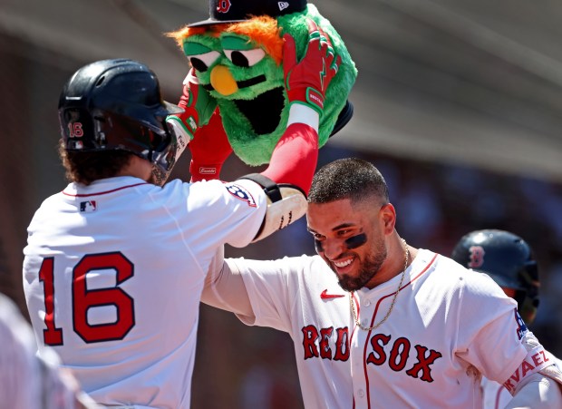 Boston Red Sox outfielder Jarren Duran crowns Carlos Narváez with the mascot head after his solo home run during the second inning at Fenway Park. (Nancy Lane/Boston Herald)