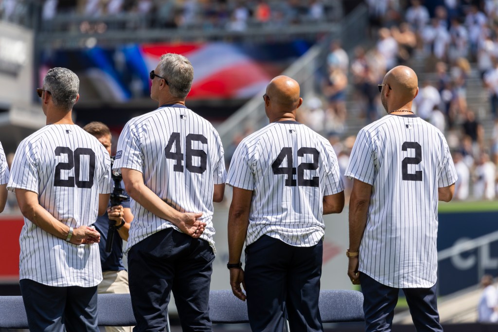 Yankees greats Jorge Posada, Andy Pettitte, Mariano Rivera, and Derek Jeter line up for the National Anthem during Old Timer's Day in 2024.