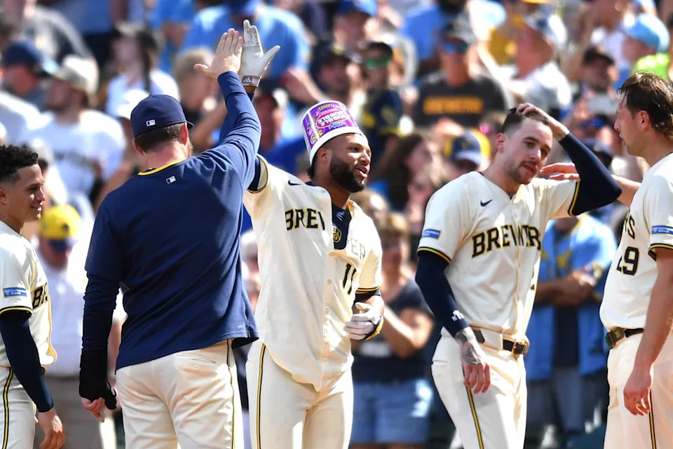Brewers center fielder Jackson Chourio wears a bubble gum bucket on his head as he celebrates his walk-off single in the 10th inning against the Dodgers with his teammates on July 9 at American Family Field.