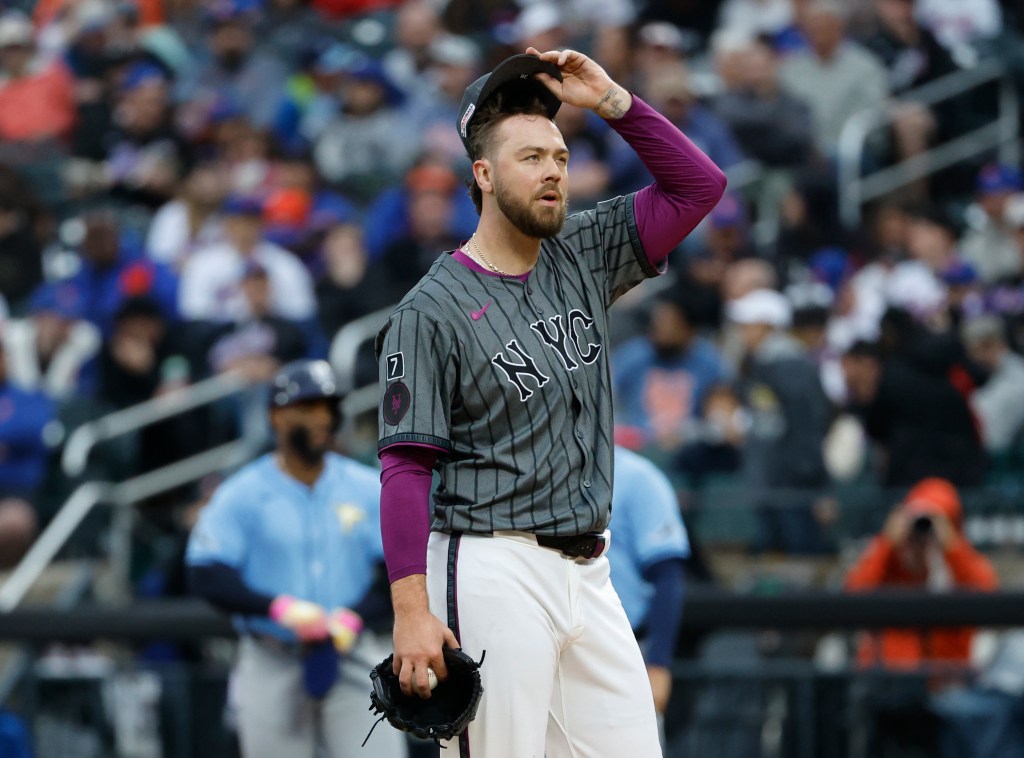 Tylor Megill #38 of the New York Mets reacts on the mound after giving up runs during the fourth inning. 