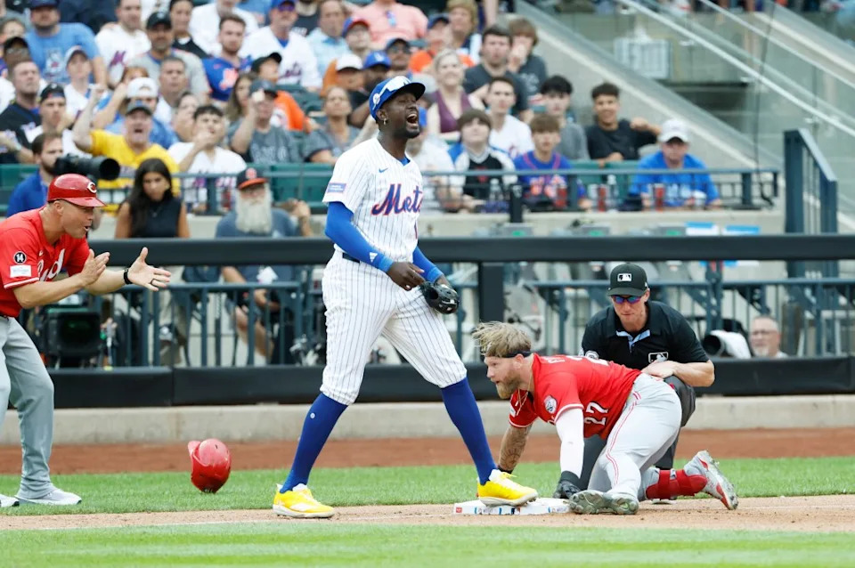 Cincinnati Reds outfielder Jake Fraley reaches third base on his RBI double as New York Mets third baseman Ronny Mauricio reacts along side him in the sixth inning at Citi Field in Queens, New York, USA, Saturday, July 19, 2025. JASON SZENES FOR THE NEW YORK POST