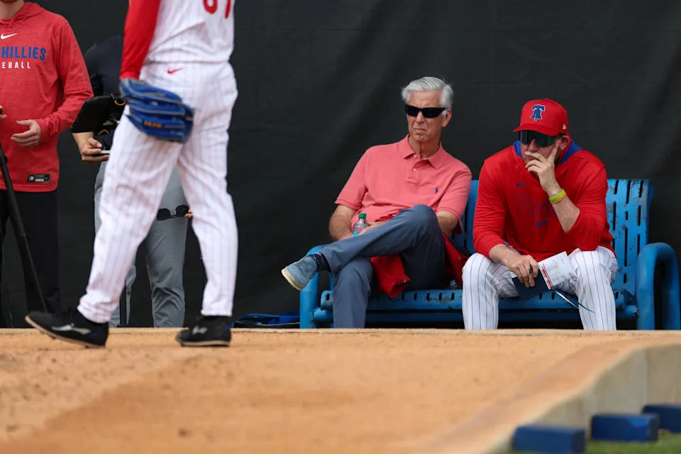 Philadelphia Phillies president of baseball operations Dave Dombrowski (left) and manager Rob Thomson (59) (right) watch bullpen sessions during spring training workouts at BayCare Ballpark.