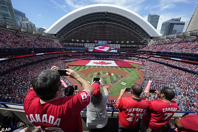 A large Canadian flag is unfurled at a Toronto Blue Jays game on Canada Day earlier in July