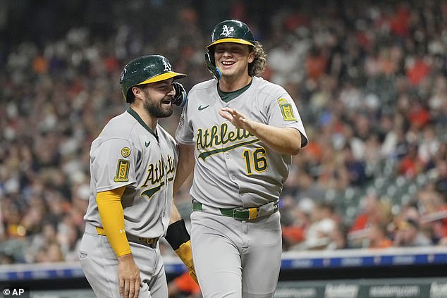 The 22-year-old is pictured celebrating with teammate Shea Langeliers after scoring in the first