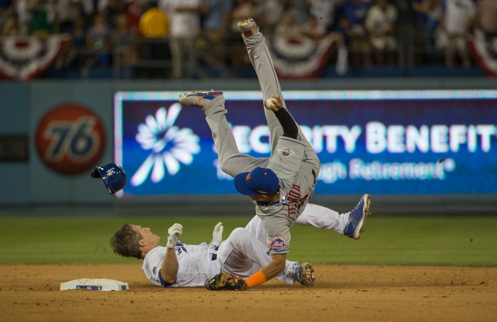 Ruben Tejada #11 of the New York Mets is kicked upside down as Chase Utley #26 of the Los Angeles Dodgers slides into him reaching for second. Tejada is taken out of the game by stretcher in the seventh inning. 
