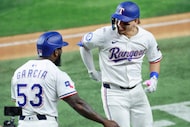 Texas Rangers Alejandro Osuna (right) is congratulated on his first Major League home run by...