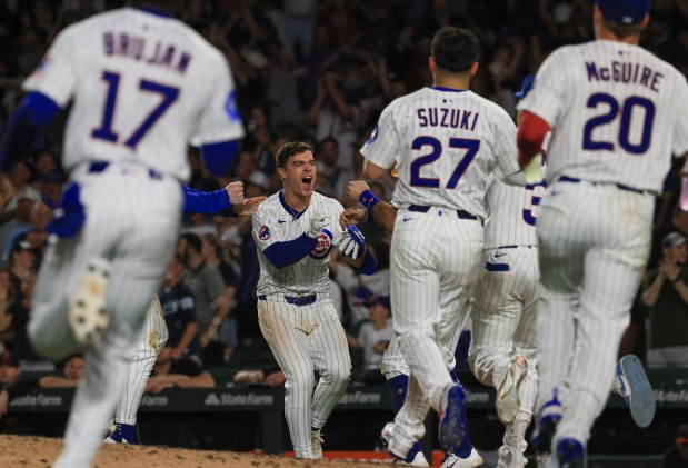 Cubs third baseman Matt Shaw, center, is congratulated after hitting a game-winning RBI sacrifice fly ball for a 1-0 win over the Guardians in ten innings at Wrigley Field on July 3, 2025, in Chicago. (John J. Kim/Chicago Tribune)