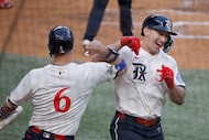 Texas Rangers outfielder Wyatt Langford (36) gets a high-five from his teammate Josh Jung...