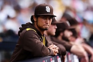 San Diego Padres' Yu Darvish looks on from the dugout during a baseball game against the...