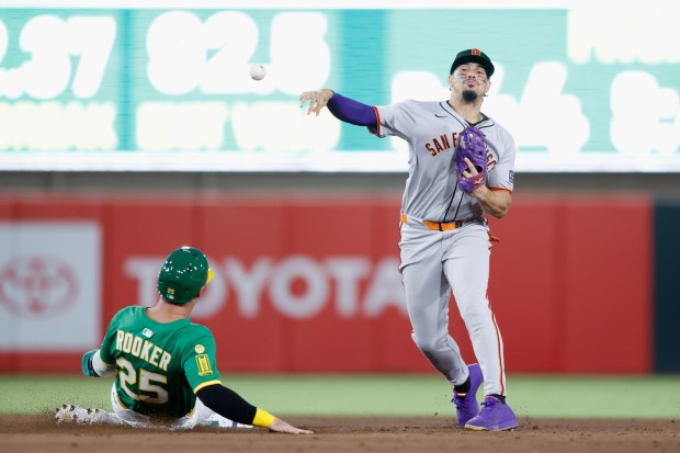 SACRAMENTO, CALIFORNIA - JULY 06: Willy Adames #2 of the San Francisco Giants turns a double play over Brent Rooker #25 of the Athletics in the bottom of the fifth inning at Sutter Health Park on July 06, 2025 in Sacramento, California. (Photo by Lachlan Cunningham/Getty Images)