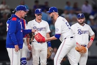 Texas Rangers pitcher Chris Martin gets the ball from manager Bruce Bochy as he comes in to...