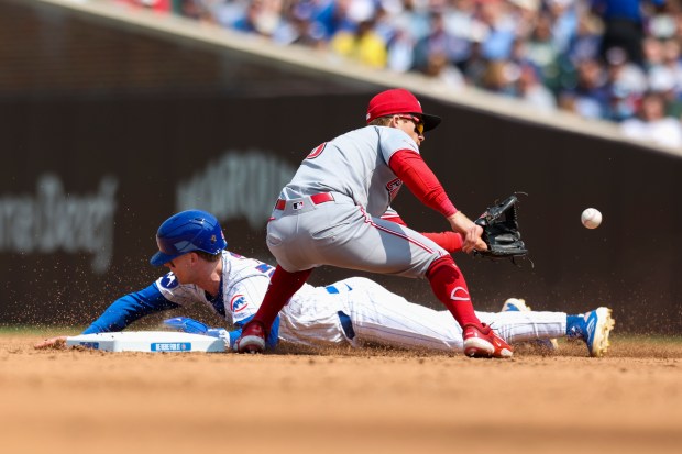 Chicago Cubs outfielder Pete Crow-Armstrong beats the tag from Cincinnati...