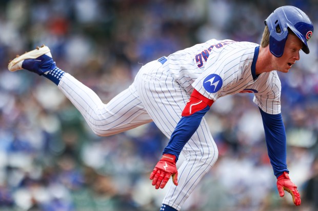 Chicago Cubs outfielder Pete Crow-Armstrong slides into third base after...