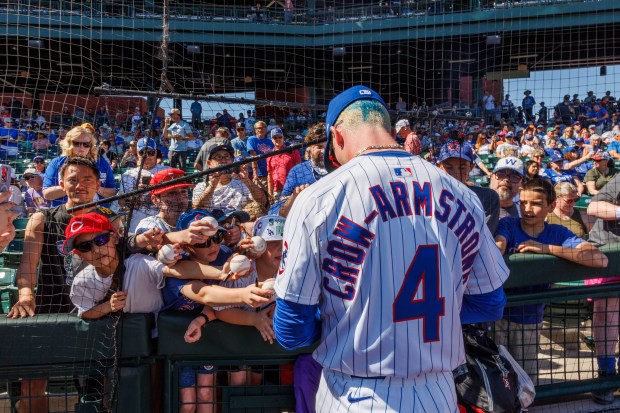 Chicago Cubs outfielder Pete Crow-Armstrong signs autographs for fans before...