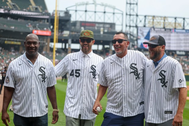 Former Chicago White Sox pitchers José Contreras, from left, Jon Garland, Freddy García, and Mark Buehrle pose for a photo after throwing out the first pitch together before the game against the Cleveland Guardians at Rate Field on Sunday, July 13, 2025. (Eileen T. Meslar/Chicago Tribune)