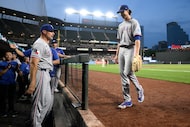 Texas Rangers starting pitcher Jacob deGrom, right, walks to the dugout after he was pulled...