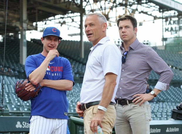 Cubs manager Craig Counsell, from left, president of baseball operations Jed Hoyer and general manager Carter Hawkins talk before a game against the Guardians on July 3, 2025, at Wrigley Field. (John J. Kim/Chicago Tribune)
