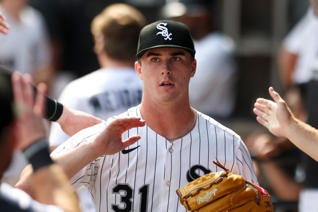 Chicago White Sox pitcher Grant Taylor (31) gets high-fives in the ninth inning against the Cleveland Guardians at Rate Field on Sunday, July 13, 2025. (Eileen T. Meslar/Chicago Tribune)