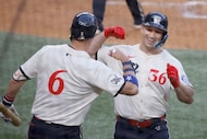 Texas Rangers outfielder Wyatt Langford (36) gets a high-five from his teammate Josh Jung...
