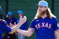 Texas Rangers pitcher Jon Gray shakes hands with catcher Tucker Barnhart after throwing a...