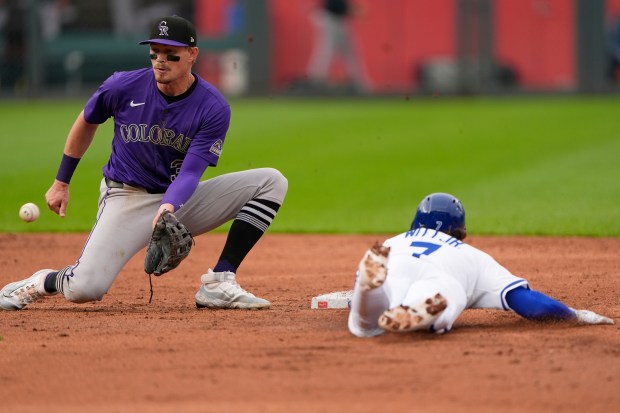 Kansas City Royals' Bobby Witt Jr. (7) beats the tag by Colorado Rockies shortstop Aaron Schunk to steal second during the third inning of the second baseball game of a doubleheader, Thursday, April 24, 2025, in Kansas City, Mo. (AP Photo/Charlie Riedel)