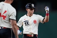 Texas Rangers' Sam Haggerty celebrates his single in the first inning of a baseball game...