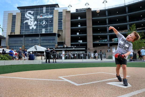 Aidan Anderson, 4, of Brookfield, throws a ball while playing catch with his father, Andrew, at the old Comiskey Park home plate outside of Rate Field before a White Sox-Cubs game on July 26, 2025. (Chris Sweda/Chicago Tribune)