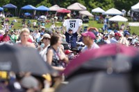 A man holds up an Ichiro Suzuki jersey before the National Baseball Hall of Fame induction ceremony in Cooperstown, N.Y., July 27, 2025. (AP Photo/Seth Wenig)