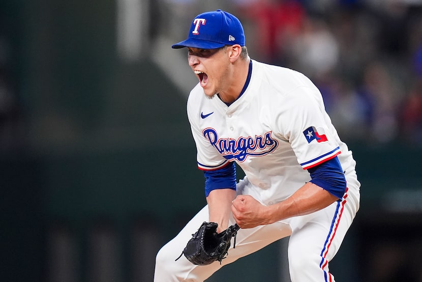 Texas Rangers pitcher Robert Garcia celebrates after striking out Athletics third baseman...