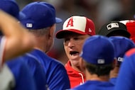 Los Angeles Angels interim manager Ray Montgomery, center, has words with Texas Rangers...