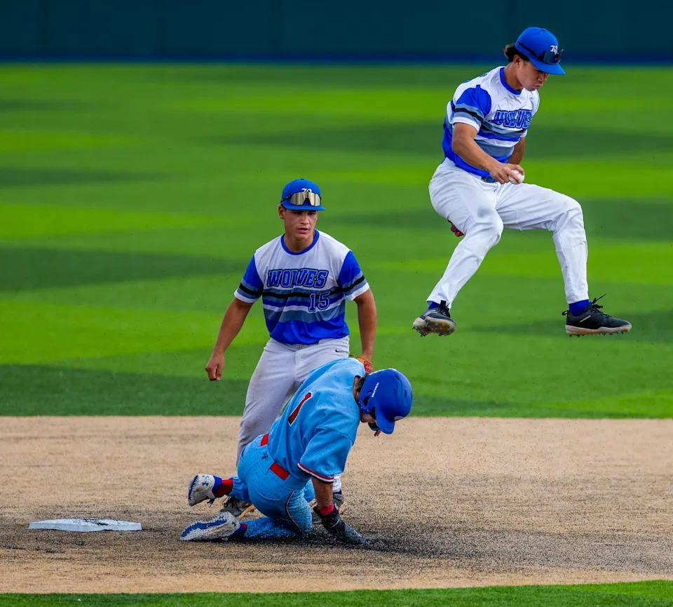 Basic infielder Tate Southisene (8) tags second base then leaps over Reno runner Jackson Berg (1) as Basic infielder Lyndon Lee (15) looks on during day one of the 5A baseball state tournament from Peccole Park at UNR on Thursday, May 15, 2025, in Reno.