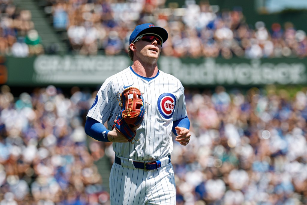Chicago Cubs center fielder Pete Crow-Armstrong (4) returns to the dugout during the first inning of a baseball game against the Seattle Mariners at Wrigley Field. 