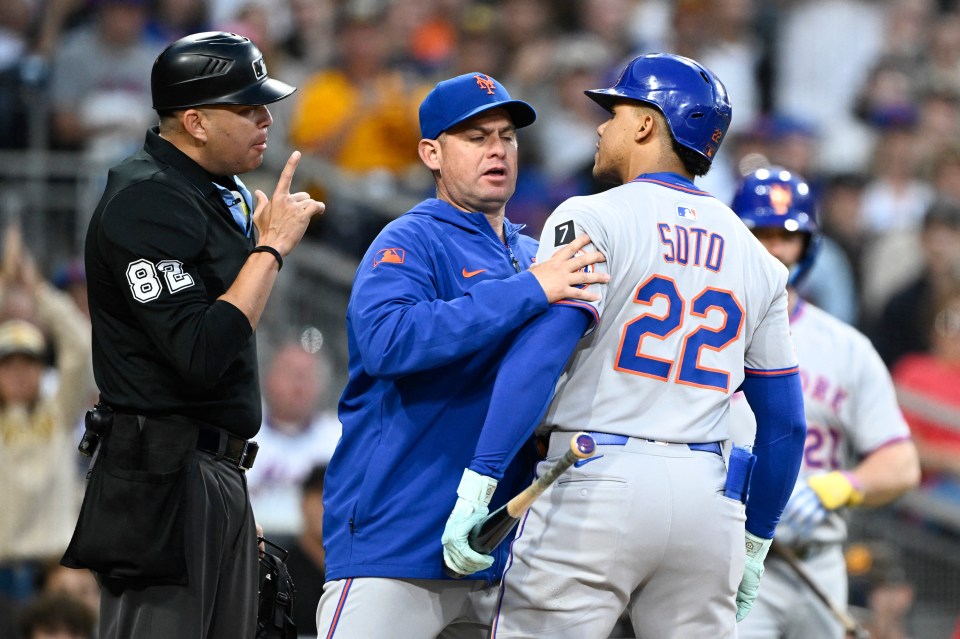 Juan Soto argues with umpire Emil Jimenez while his manager holds him back.