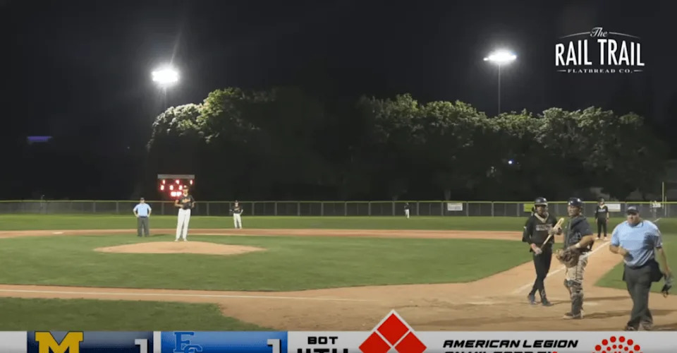 The umpire stops the game and looks toward the stands. @MyMilfordTV/YouTube