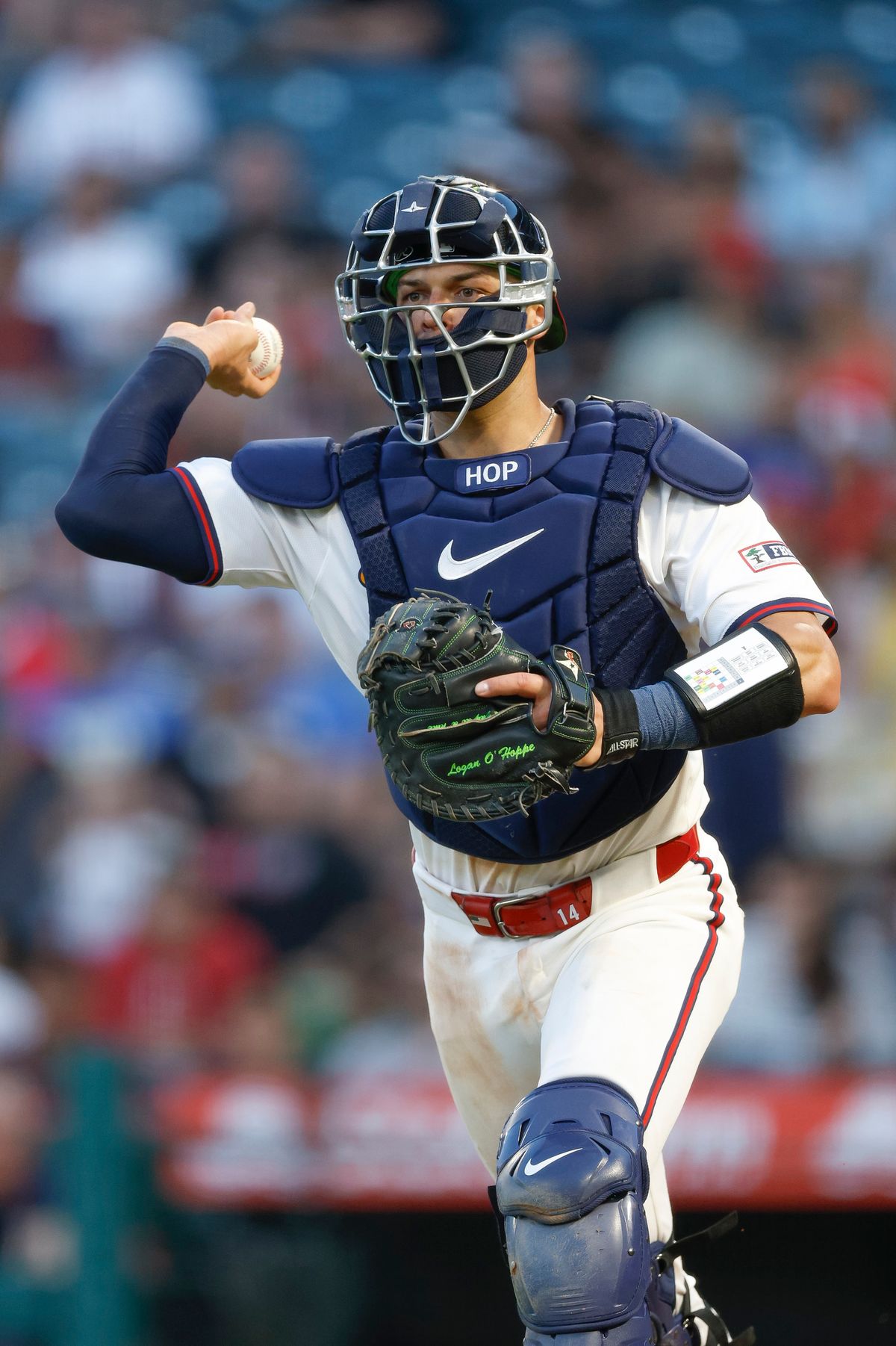 Logan O'Hoppe #14 of the Los Angeles Angels in a rundown during a game against the Texas Rangers at Angel Stadium on July 10, 2025, in Anaheim, California.