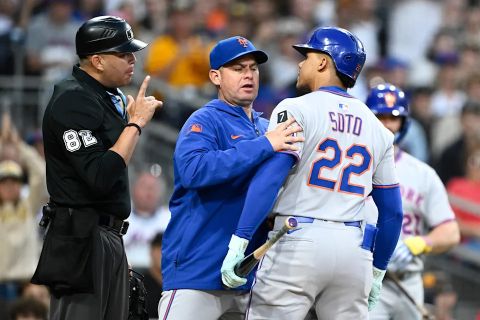 New York Mets right fielder Juan Soto (22) argues with umpire Emil Jimenez (82) as manager Carlos Mendoza (64) holds him back after a called strikeout during the third inning against the San Diego Padres on July 28, 2025, at Petco Park.