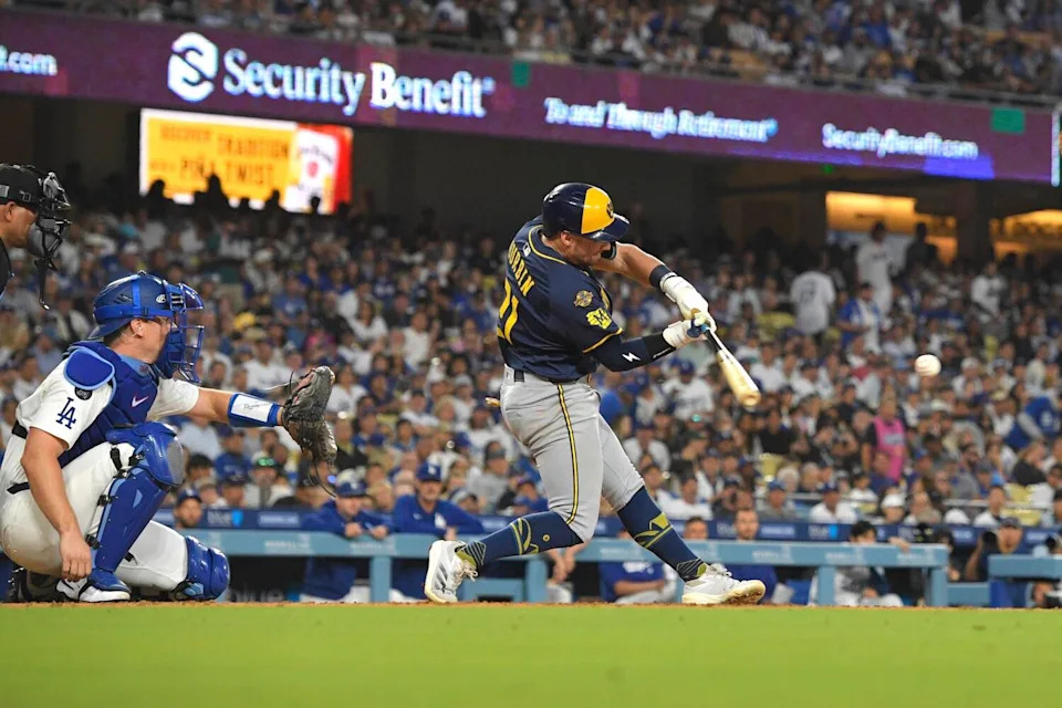 Milwaukee's Caleb Durbin hits a run-scoring double in front of Dodgers catcher Will Smith in the fifth inning Friday.