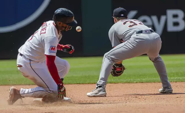 Cleveland Guardians' Angel Martinez, left, slides safely into second base as Detroit Tigers' Colt Keith waits for the throw during the seventh inning of a baseball game, Sunday, July 6, 2025, in Cleveland. (AP Photo/Phil Long)