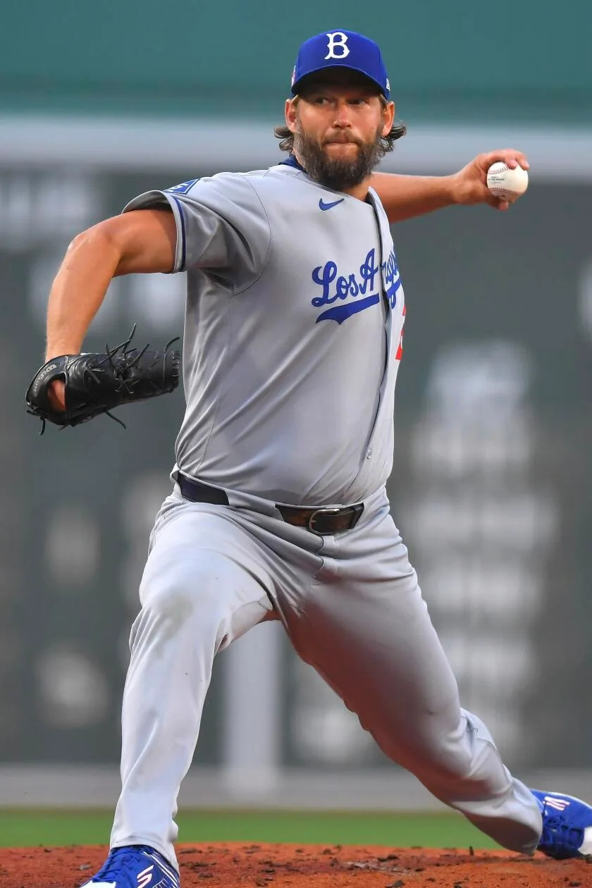 Los Angeles Dodgers' Clayton Kershaw winds up for a pitch to a Boston Red Sox batter.