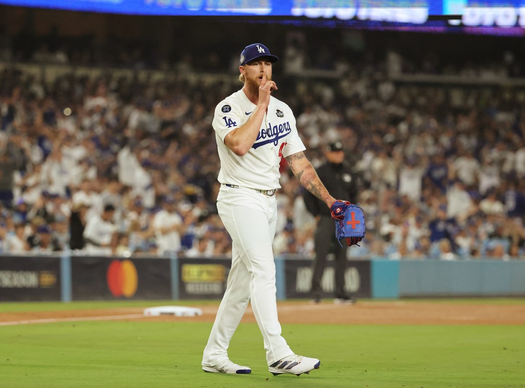 Los Angeles Dodgers pitcher Michael Kopech signals for quiet.