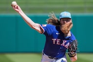Texas Rangers pitcher Jon Gray pitches during the first inning of a spring training game...