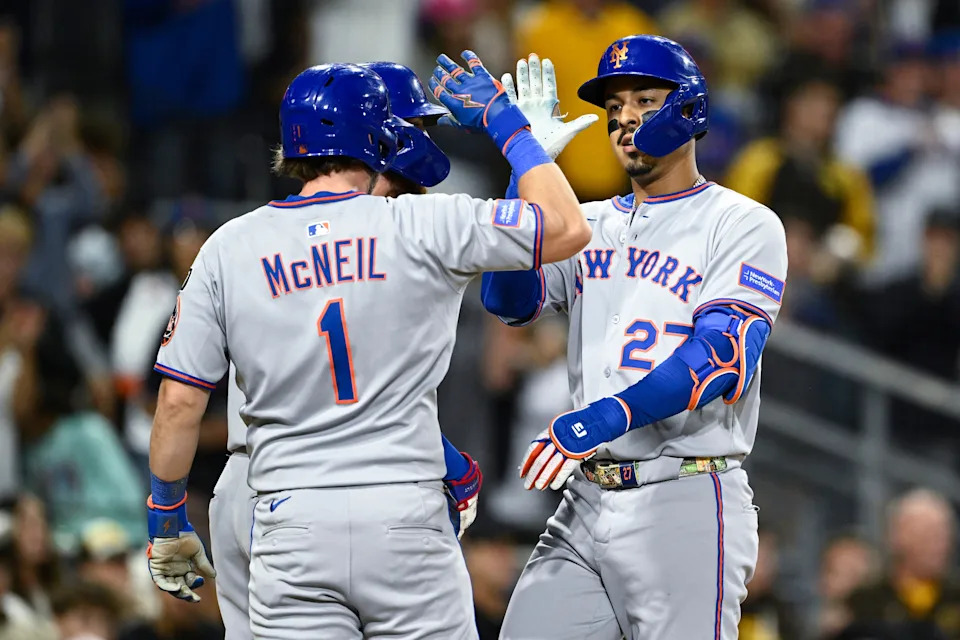 New York Mets third baseman Mark Vientos (27) is congratulated by Brandon Nimmo (9) and Jeff McNeil (1) after hitting a grand slam during the fifth inning against the San Diego Padres on July 28, 2025, at Petco Park.
