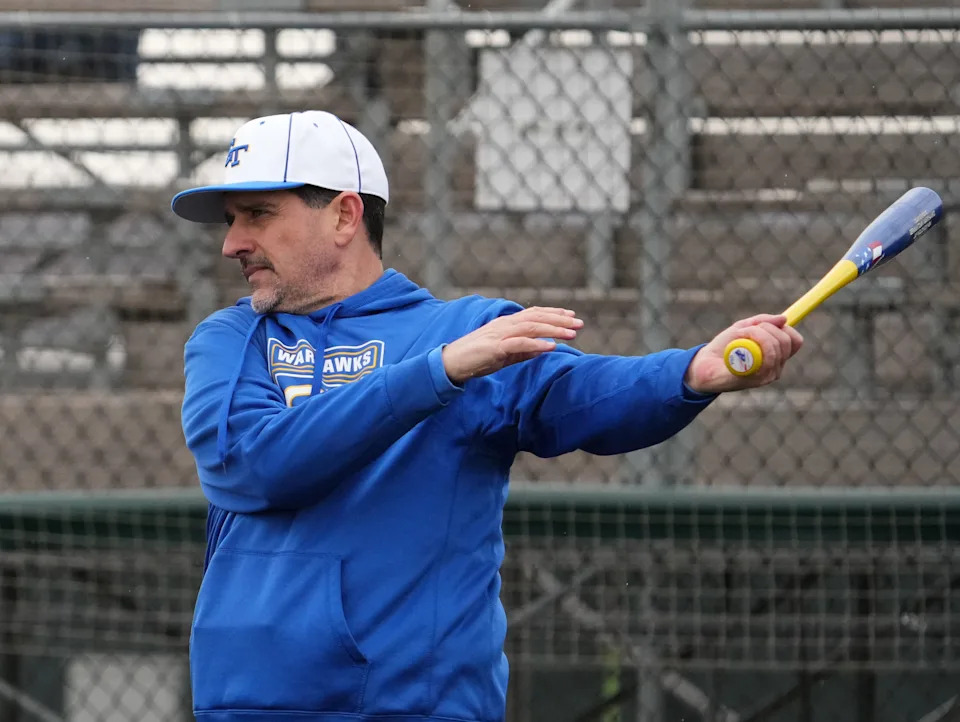 Germantown baseball head coach Jay Wojcinski hits to players prior to a doubleheader against Brookfield East at The Rock Sports Complex in Franklin, Friday, April 4, 2025. Brookfield East won the first game, 3-2, and lost the second game, 13-3.