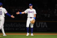 Texas Rangers third baseman Josh Jung, right, congratulates closing pitcher Cole Winn, left,...